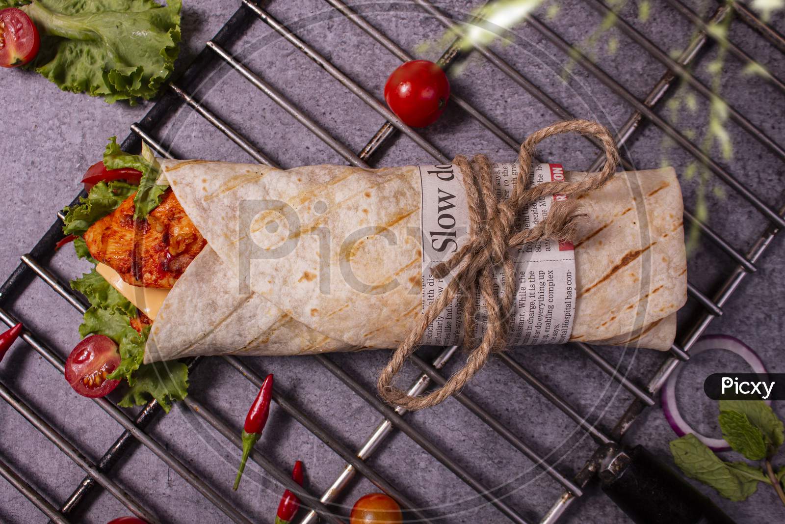 Fresh Grilled Chicken Roll With Fresh Tomatos, Salad, Cheese And Onions Isolated On Bright Blue Background. Top View.Selective Focus