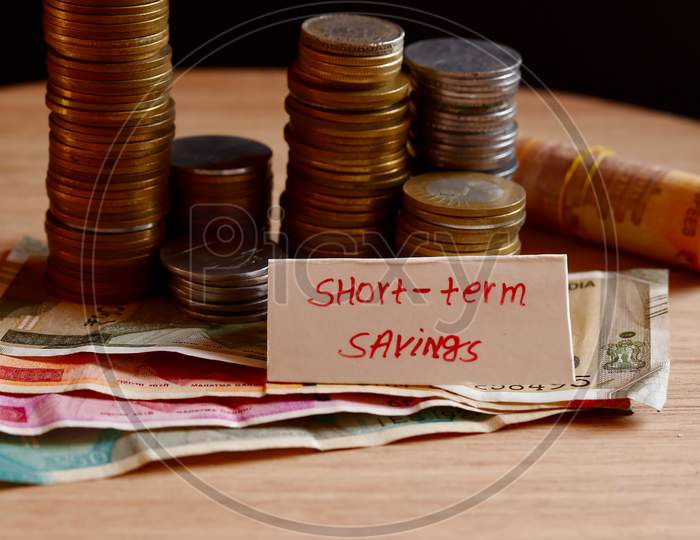 Short Term Saving Writing And Indian Coin And Cash(Note) Collection Beautiful View, Management Of Short Term Saving, Coin-Cash Rotation Background With Short Term Saving