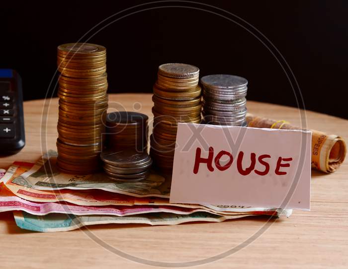 House Saving Money,Financial Planning Concept,Coins And Rupees On Table,Home Saving Coins In Jar,Real Estate Investment,Indian Rupee Collect For House,