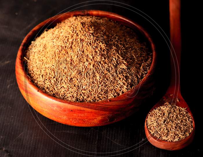 Carvi Seeds On Wooden Table,Caraway Healthy Spice In Wooden Spoon,Jiza Or Cumin Seeds On Black Background,