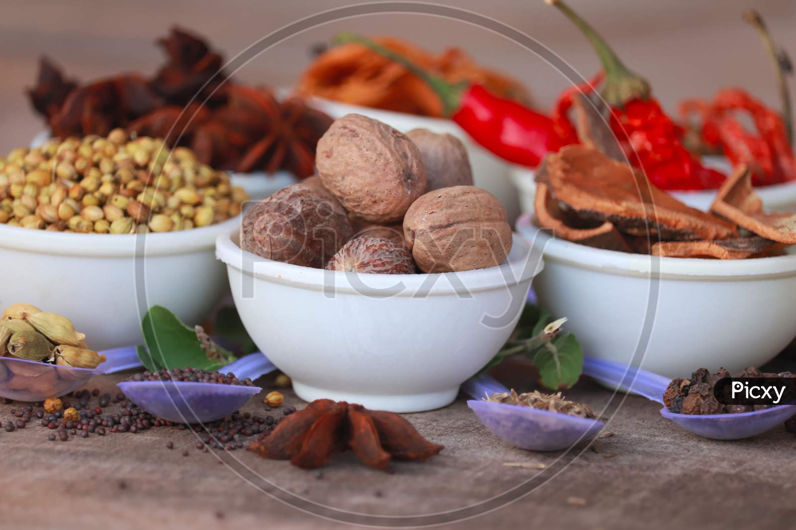 Group Of Indian Spices And Herbs Difference Ware On Wooden Teblet,Different Spices In Spoons On Table,Indian Bay Leaf, Garam Masala, Mace, Javitri, Nutmeg, Jaipha