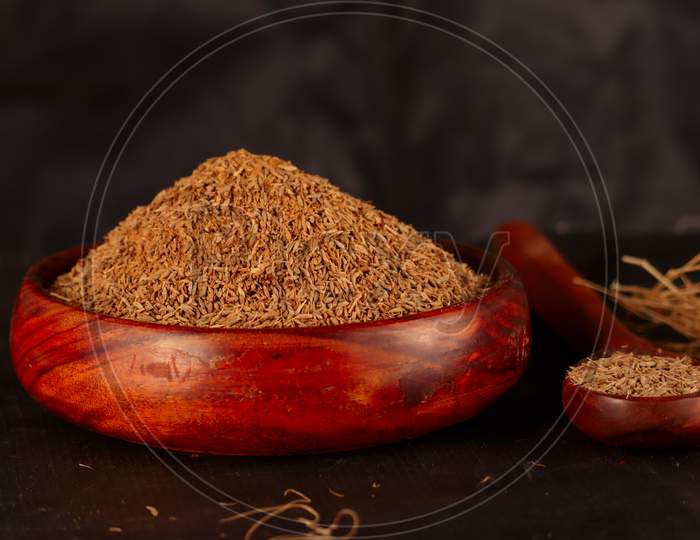 Carvi Seeds On Wooden Table,Caraway Healthy Spice In Wooden Spoon,Jiza Or Cumin Seeds On Black Background,