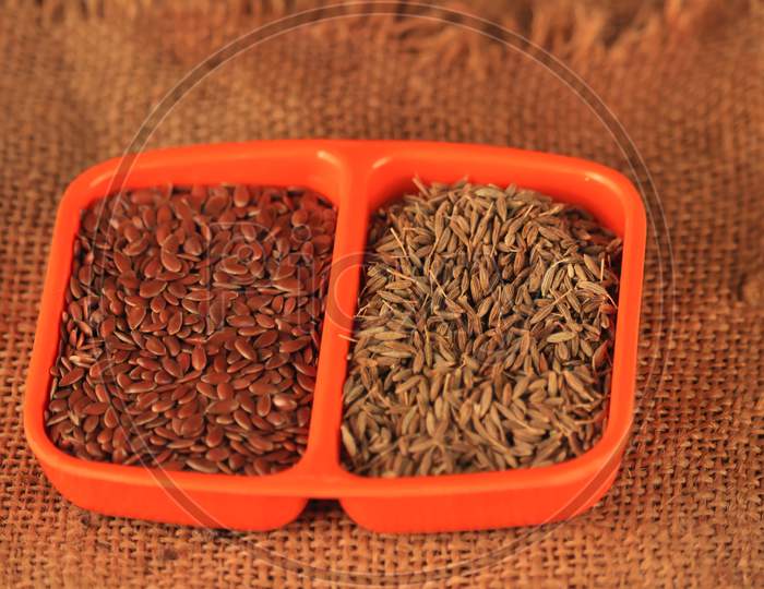 Cumin And Flax Have Fallen Into An Orange Bowl,Indian Spice Caraway And Flex Seeds