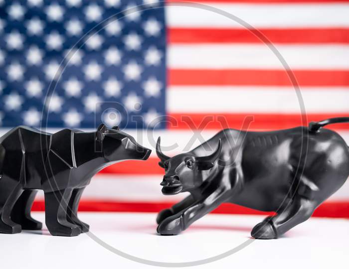 Stock Market Bull And Bear With American Flag As Background - Concept Of Investment In Us Equity Shares Market.