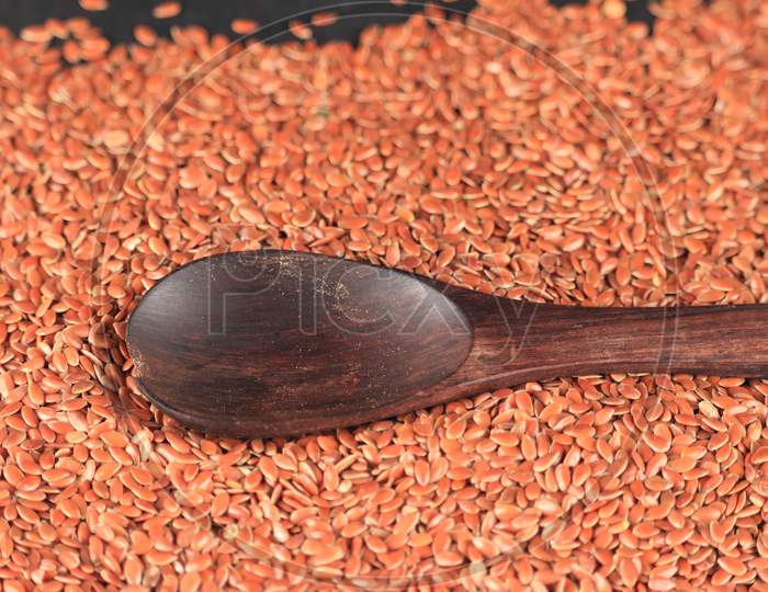 Spoon With Flax Seed,Brown Flax Seeds,Linum Usitatissimum,Also Known As Linseed, Brown Flax Seed Or Linseed,Close Up Organic Flax Seeds