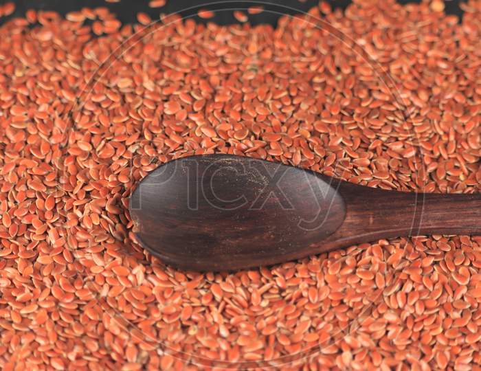 Spoon With Flax Seed,Brown Flax Seeds,Linum Usitatissimum,Also Known As Linseed, Brown Flax Seed Or Linseed,Close Up Organic Flax Seeds