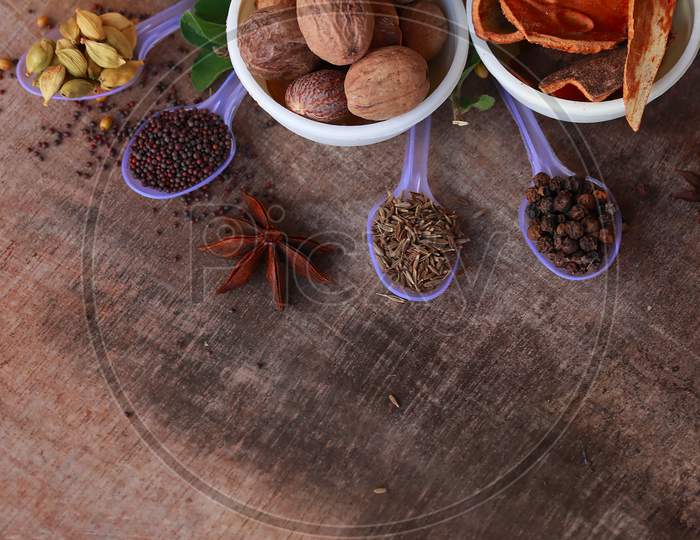 Spice Background, Top View.Rotation All Indian Spices On Wooden Table,Indian Cuisine,Cumin, Black Pepper, Cloves, Cardamom, Fennel, Bay Leaf,Background Rotating,