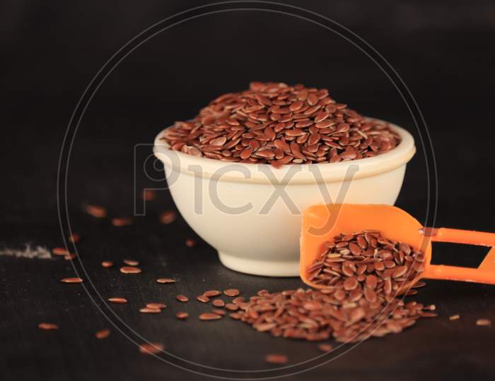 Flex Seeds In A White Bowl With The Black Background,High Fibre Flex Seed In Bowl,Linum Usitatissimum,Also Known As Linseed
