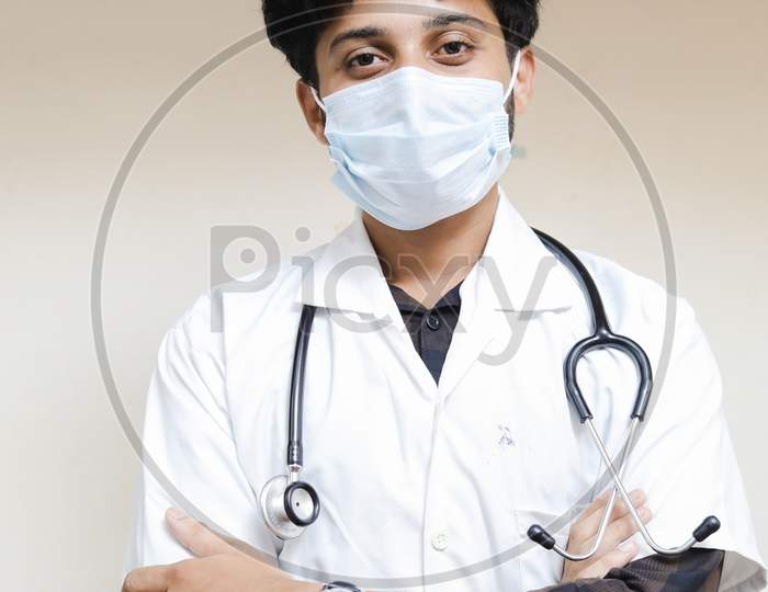 Indian young doctor sitting on chair, doctor office, doctor in clinic