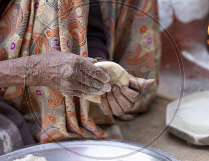 Senior Woman Hand Making Chapati. Selective Focus