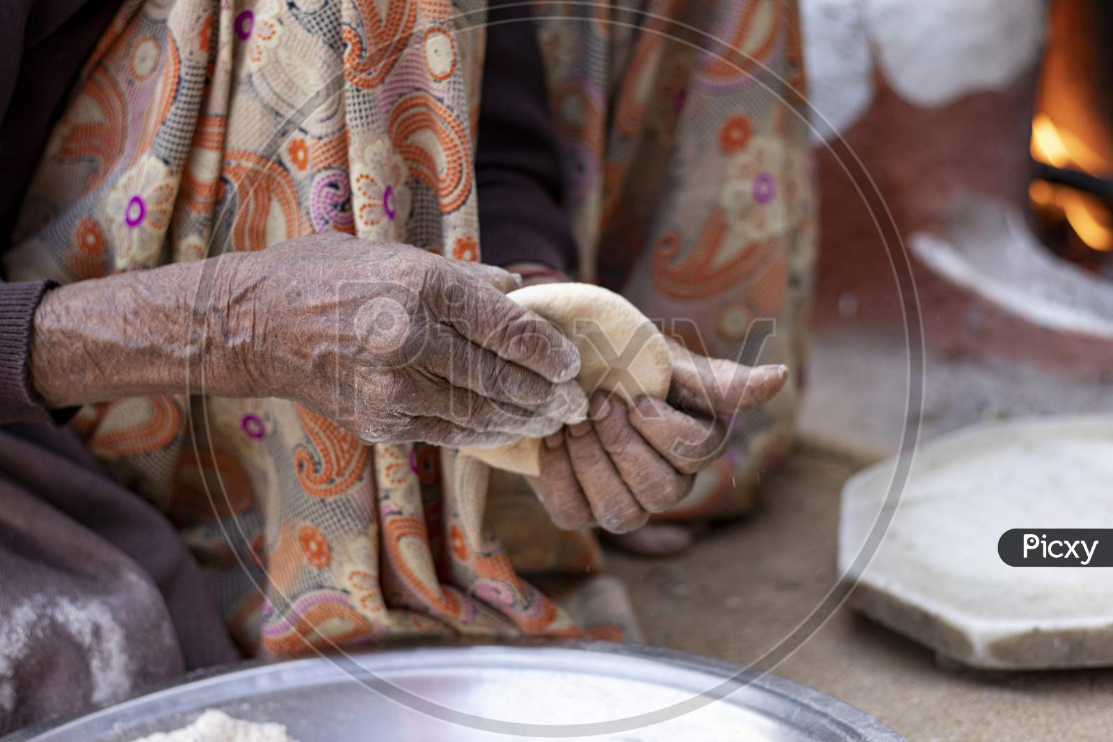 Senior Woman Hand Making Chapati. Selective Focus
