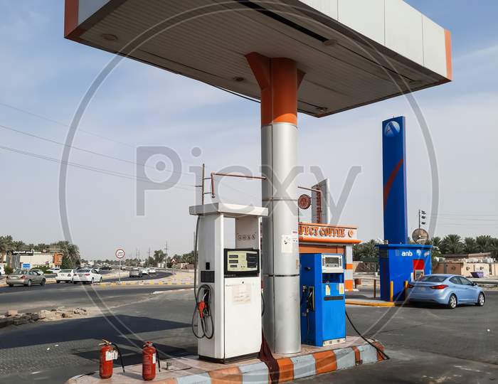 Petrol filling machine and human on the petrol pump.