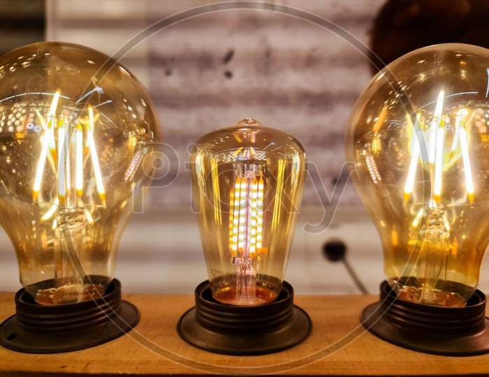 Close Up View Of Vintage Light Bulbs With Warm Yellow Light.