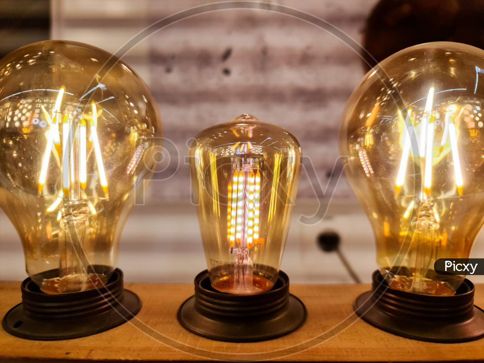 Close Up View Of Vintage Light Bulbs With Warm Yellow Light.