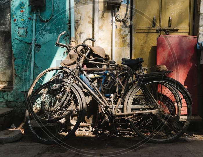 Old Broken Bicycles Left Outside Of The House