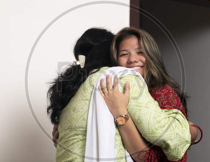 Young Indian Girl Hugging Her Mother With Love, Feeling Happy. Daughter And Mother Concept.