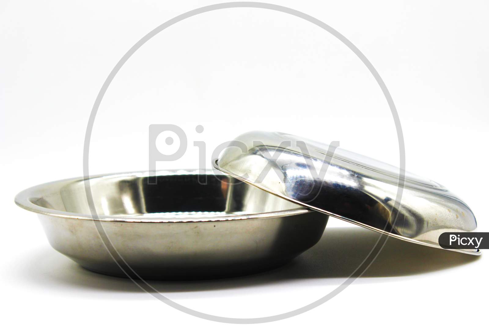 Stainless Steel Plates On White Background With Selective Focus