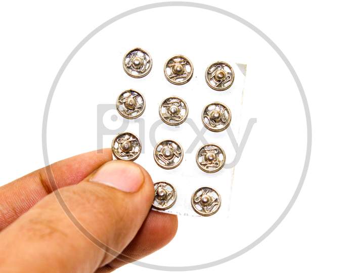 Steel Buttons On White Background With Selective Focus