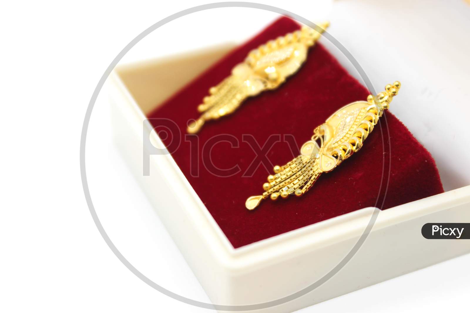 A Picture Of Golden Earrings With Selective Focus