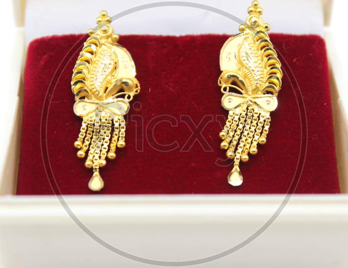 A Picture Of Golden Earrings With Selective Focus