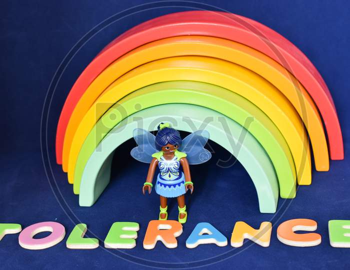 Vaduz, Liechtenstein, October 15, 2021 Black Human Toy And The Word Tolerance In Front Of A Rainbow