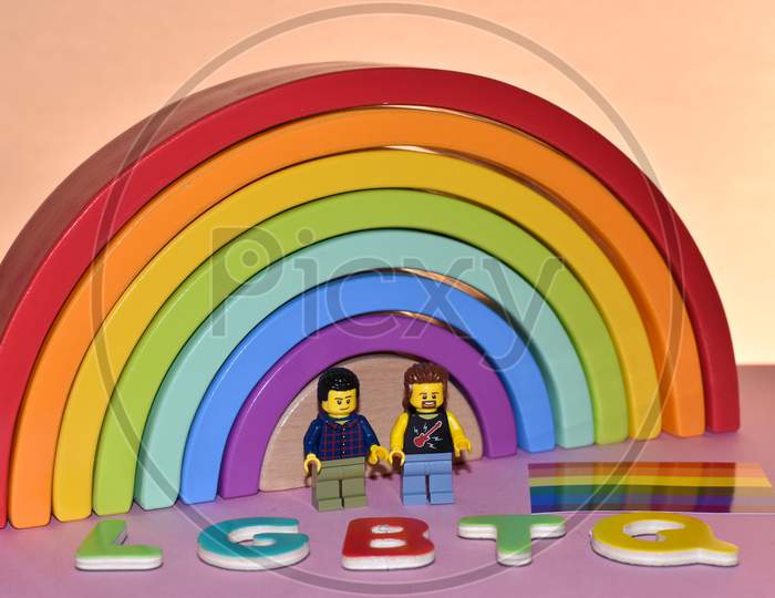Vaduz, Liechtenstein, October 17, 2021 Human Toy Gay Pair In Front Of A Rainbow