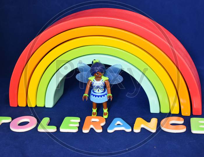 Vaduz, Liechtenstein, October 15, 2021 Black Human Toy And The Word Tolerance In Front Of A Rainbow