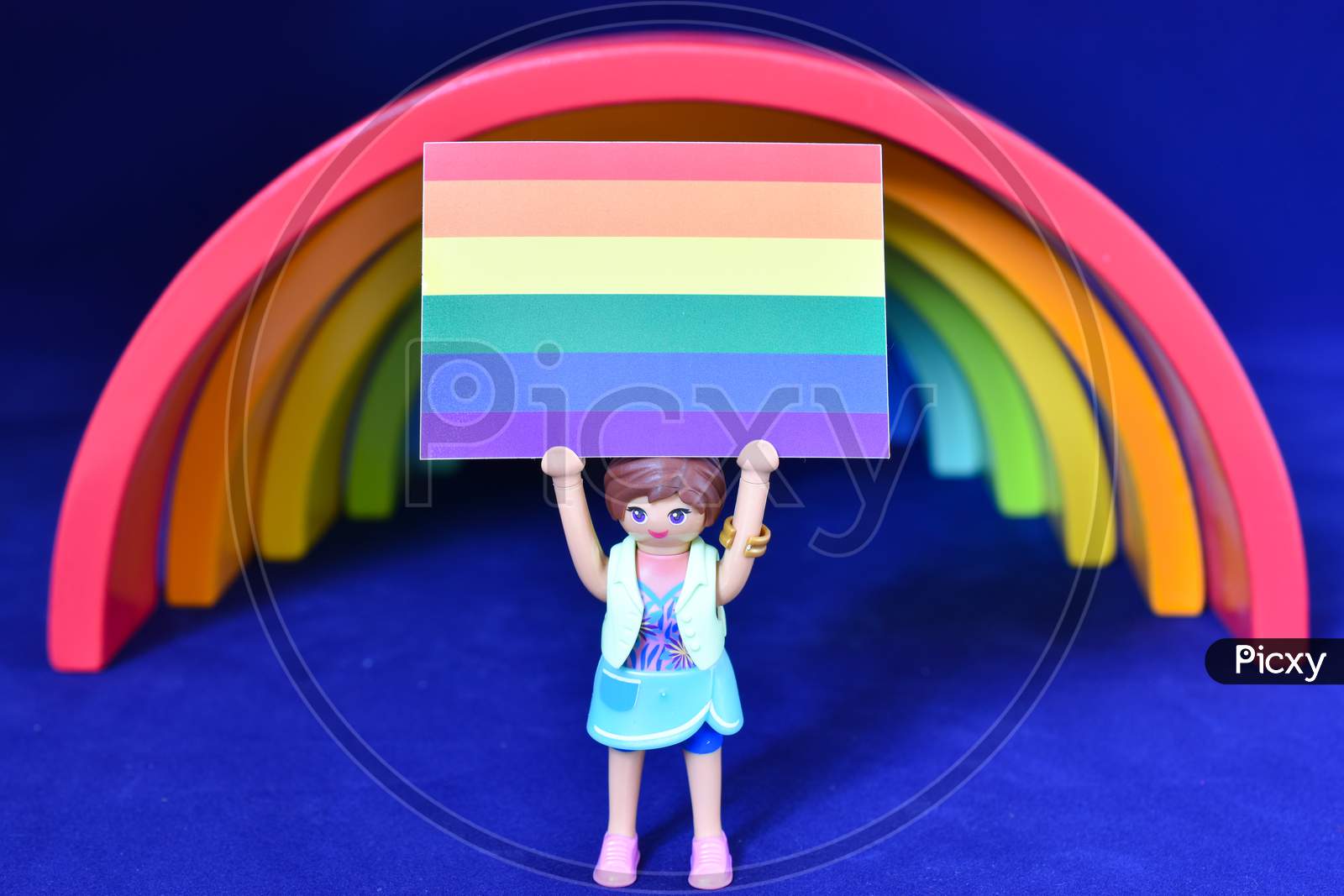 Vaduz, Liechtenstein, October 15, 2021 Human Toy With A Gender Flag In Front Of A Rainbow