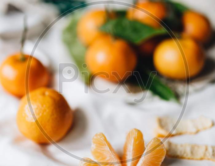 Tangerins with leaves on a white linen