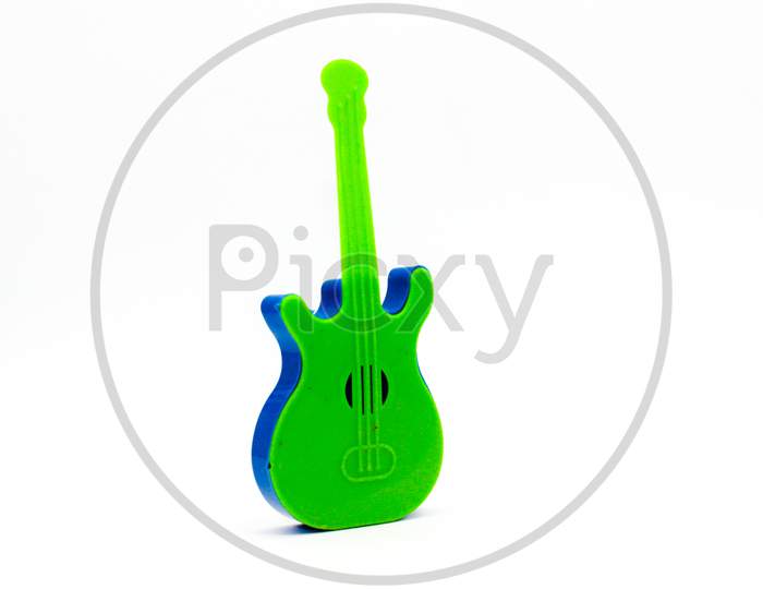 Toy Guitar On White Background With Selective Focus