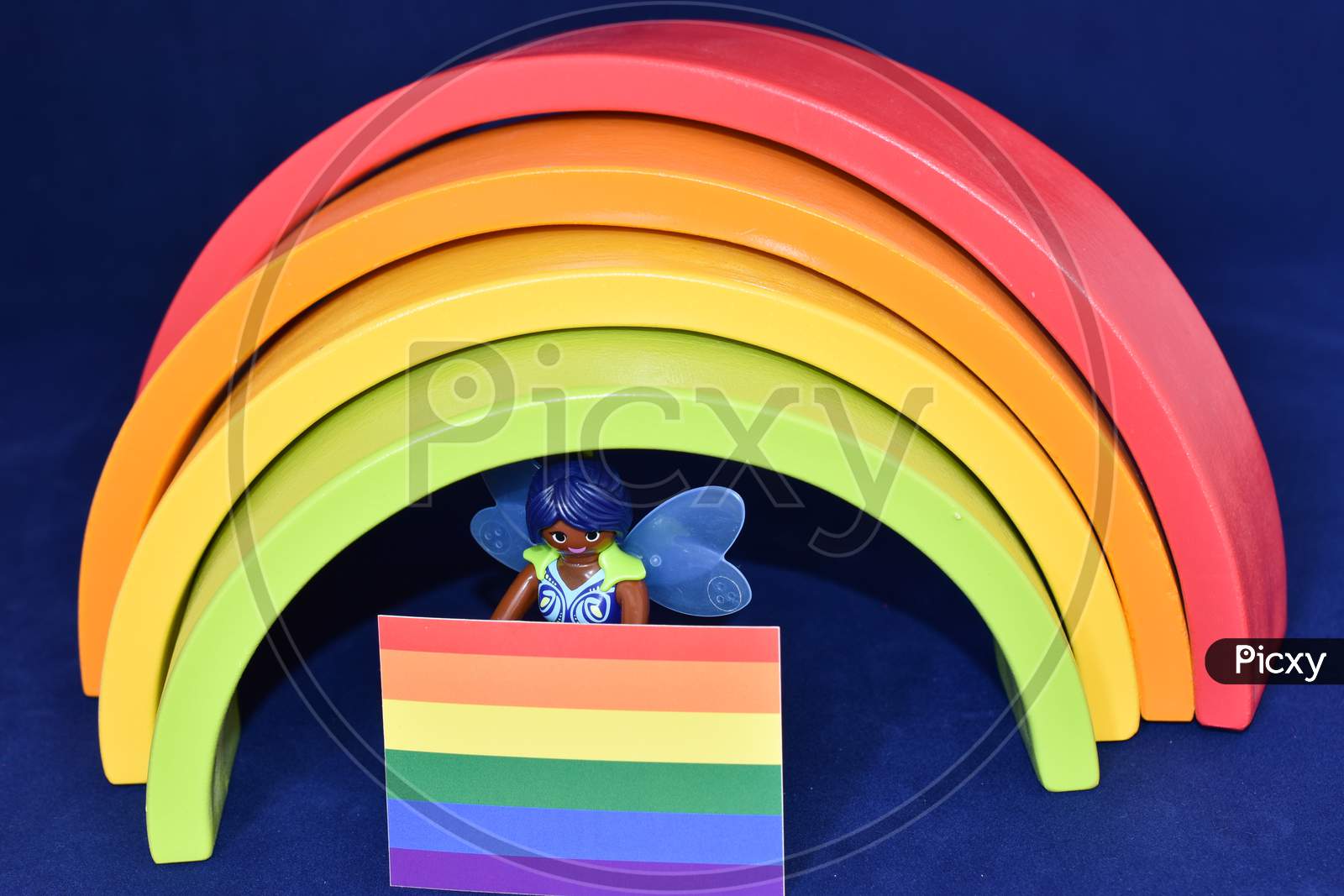 Vaduz, Liechtenstein, October 15, 2021 Angel Toy With A Gender Flag In Front Of A Rainbow