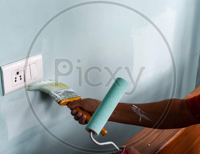 Hand Painting Wall With Roll And Brush