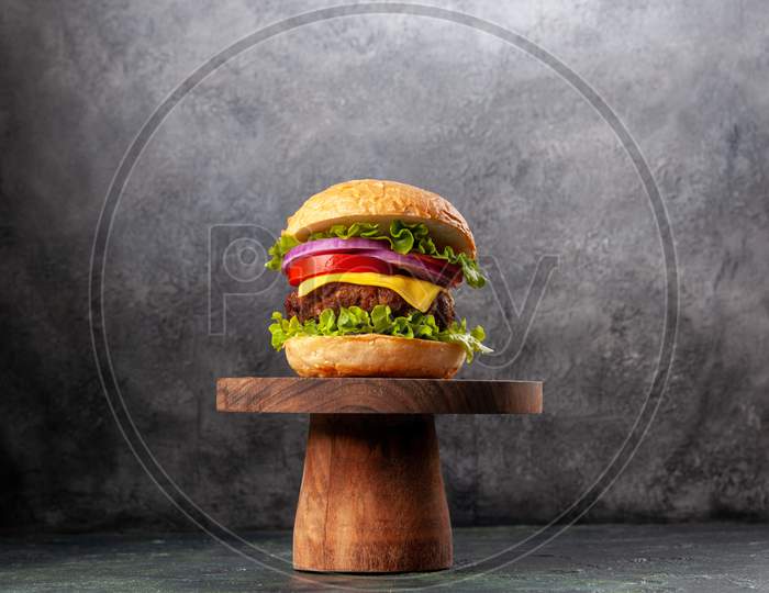 Tasty Sandwich On Wooden Cutting Board On Dark Mix Color Background