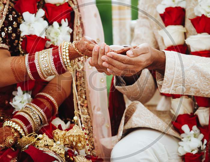 Hands Of Indian Bride And Groom Intertwined Together Making Authentic Wedding Ritual