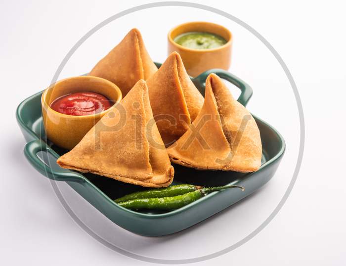 Veg Samosa - Is A Crispy And Spicy Indian Triangle Shape Snack Which Has Crisp Outer Layer Of Maida & Filling Of Mashed Potato, Peas And Spices