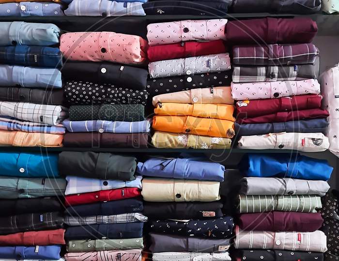 Perfectly Folded Clothes On A Shelf In Textile Shop Vertical View