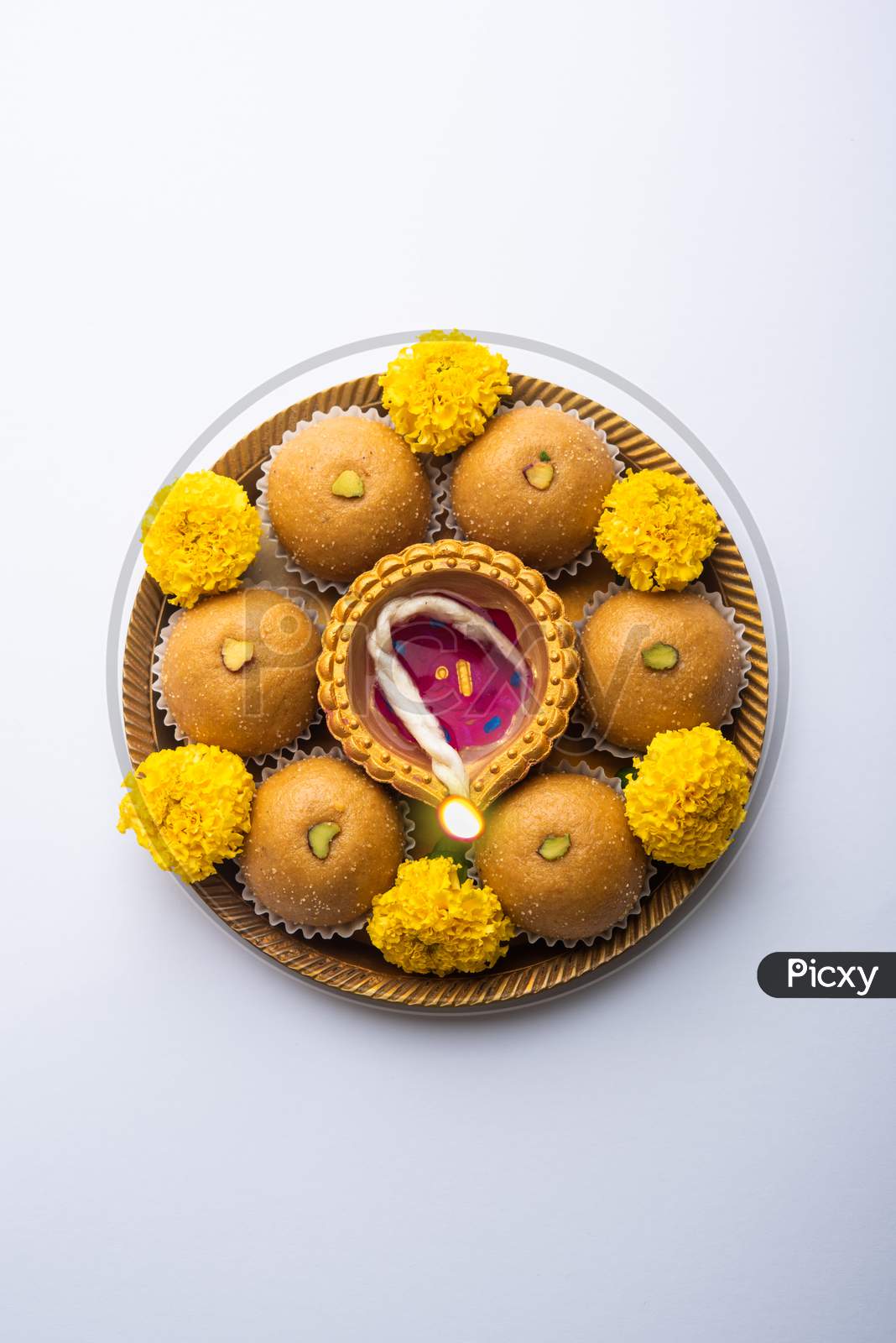 Besan Ladoo And Diwali Diya Or Clay Lamp Decorated In A Plate With Marigold Flowers - Happy Diwali Greeting