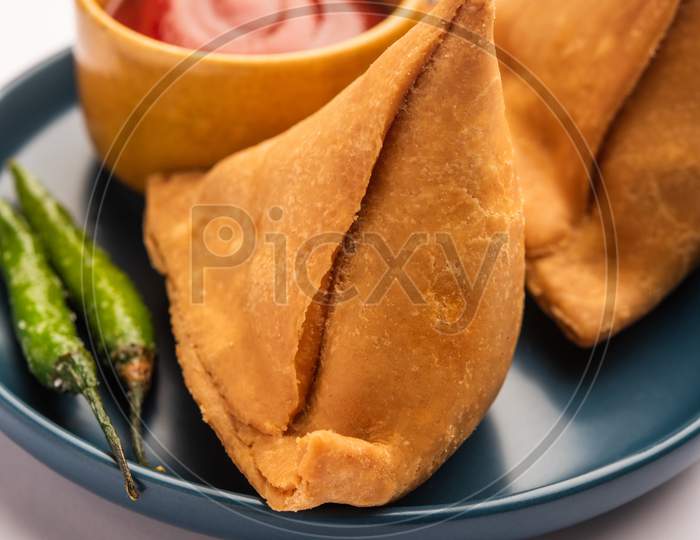 Veg Samosa - Is A Crispy And Spicy Indian Triangle Shape Snack Which Has Crisp Outer Layer Of Maida & Filling Of Mashed Potato, Peas And Spices