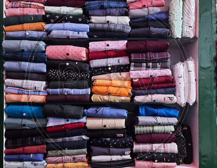 Perfectly Folded Clothes On A Shelf In Textile Shop Horizontal View