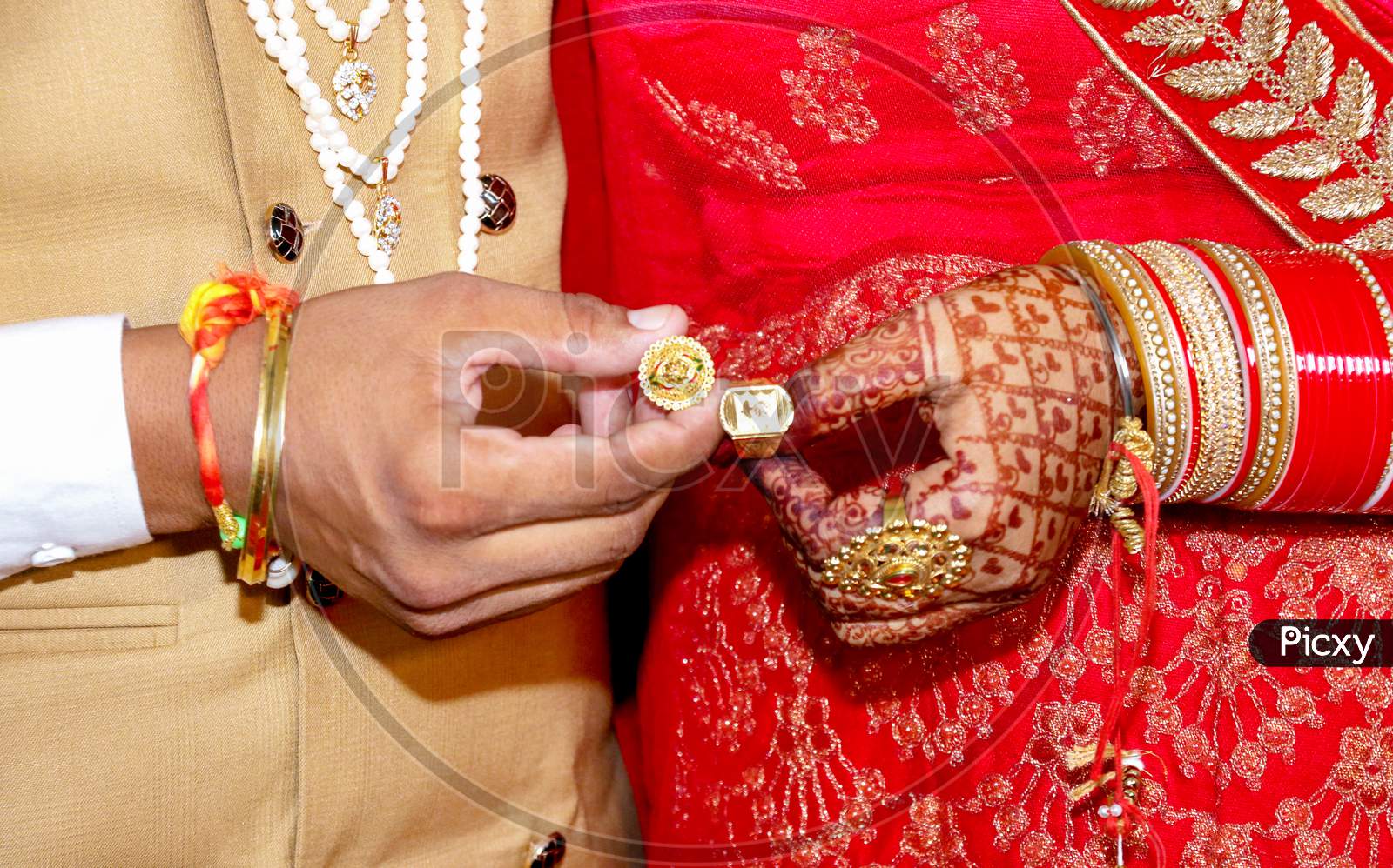 Bride And Groom Hands Holding & Showing Wedding Jewelry Rings