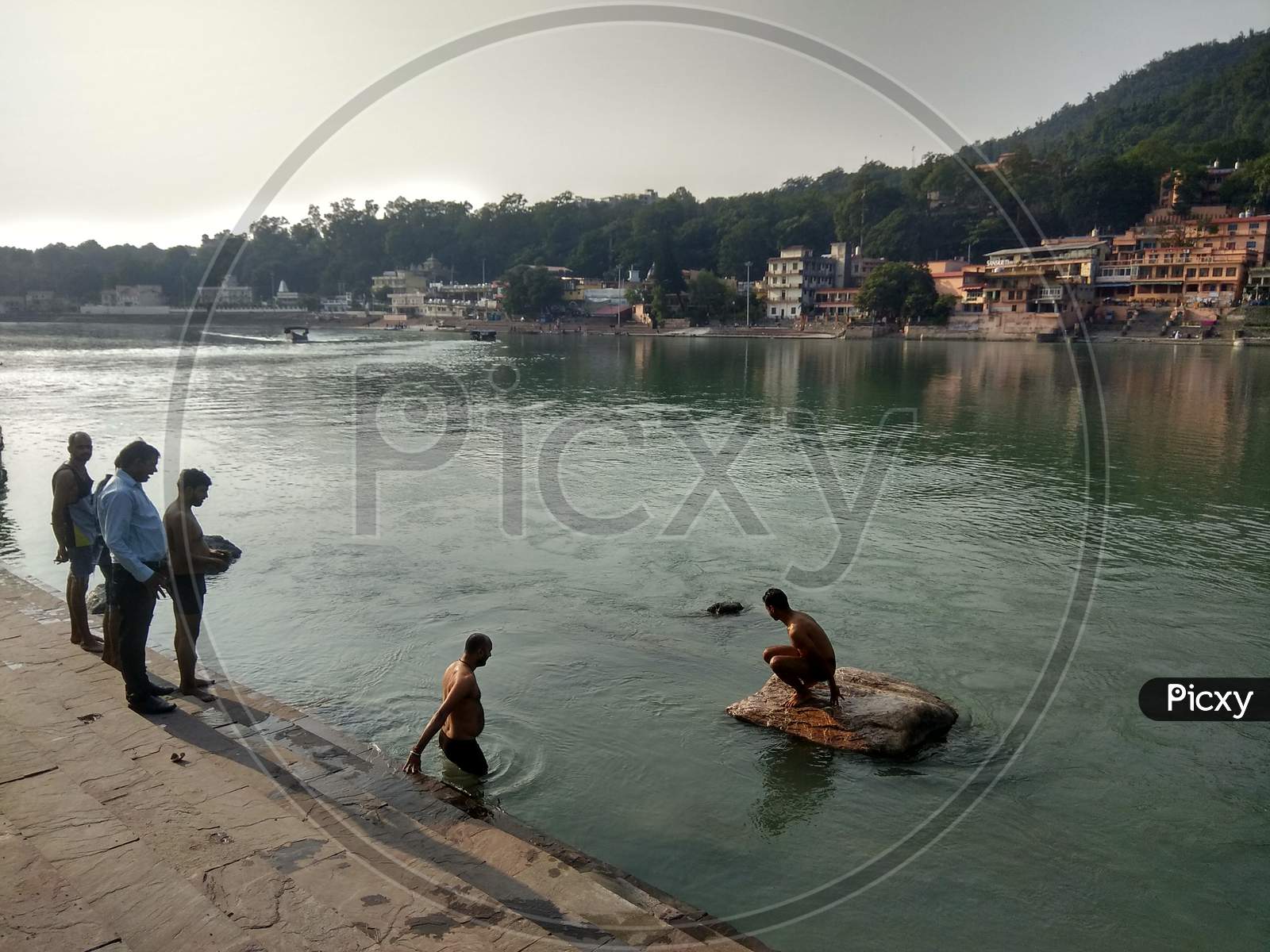 A river side ghat with people taking dip