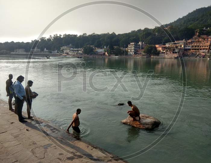 A river side ghat with people taking dip