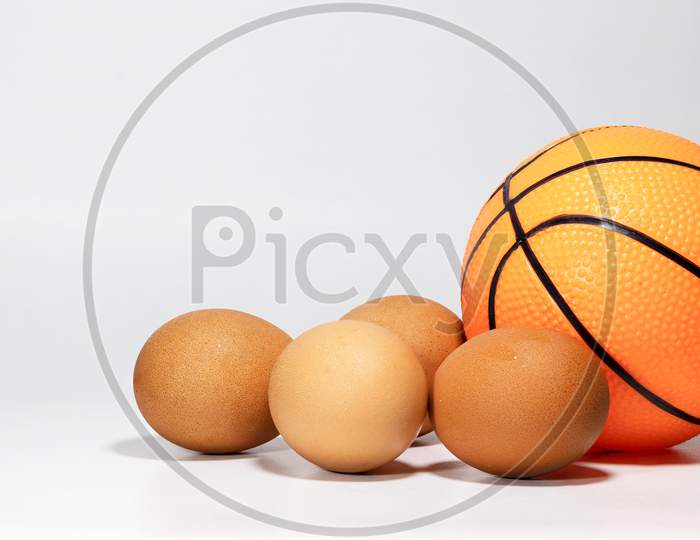 Eggs and ball closeup view with white screen