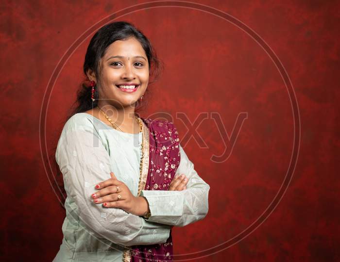 Portrait Of Successful Smiling Indian Girl In Traditional Dress With Arms Crossed Looking At Camera - Concept Of Confidence And Woman Empowerment.