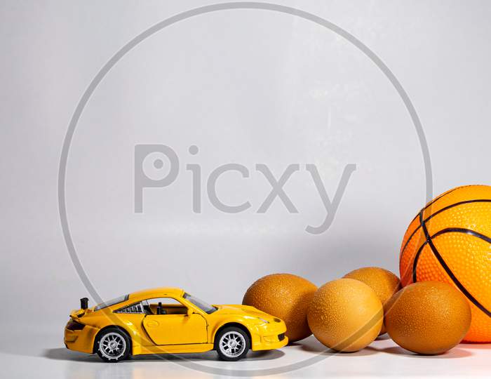 Eggs , car and ball closeup view with white screen