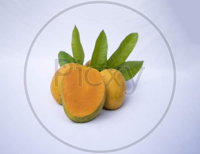 Fresh Delicious Slice Yellow Ripe Mango with Green leaf on isolated Background