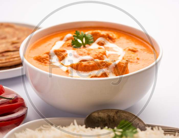 Tasty Butter Chicken Curry Dish From Indian Cuisine Served With Rice And Paratha