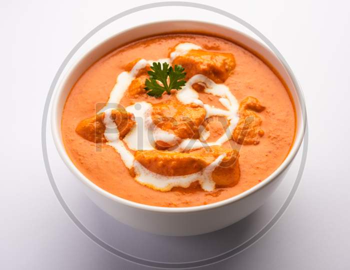 Tasty Butter Chicken Curry Dish From Indian Cuisine Served With Rice And Paratha