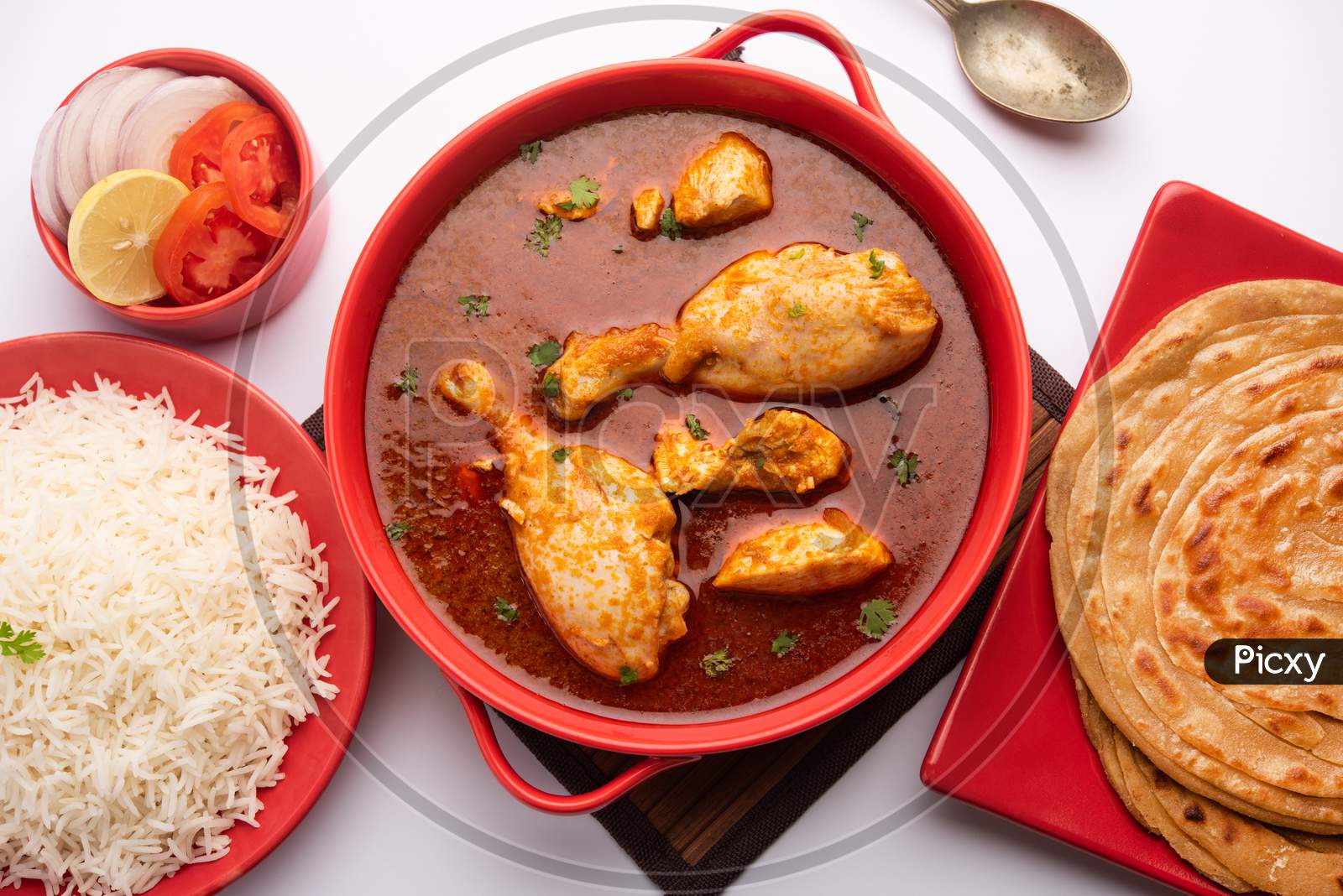 Traditional Indian Chicken Tikka Masala Or Curry Served With Rice And Laccha Paratha Or Roti