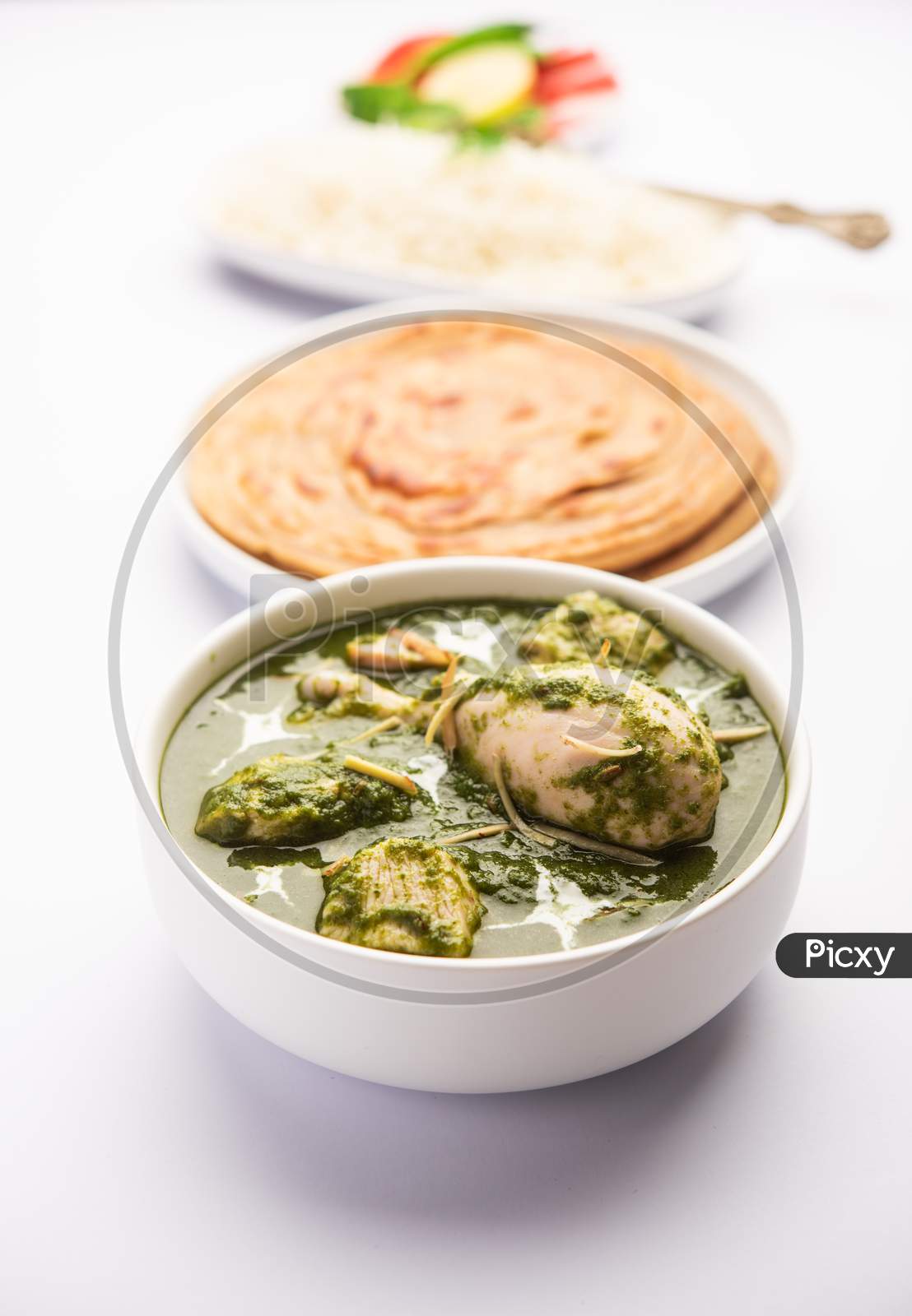 Green Palak Chicken Curry Or Murgh Hariyali Tikka Masala Or Spinach Murg Saagwala Served With Rice And Laccha Paratha
